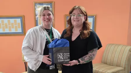 AAACU Team members pose with bags of trash they cleaned up in the community.
